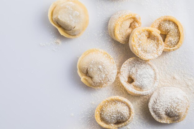 Raw fresh dumplings  or italian tortellini pasta isolated on white background