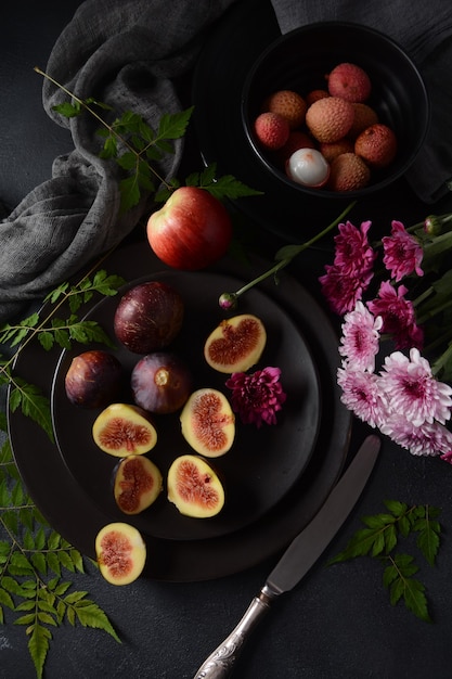 Raw fresh fig fruits on dark background. Slices of fresh common fig (Ficus carica)