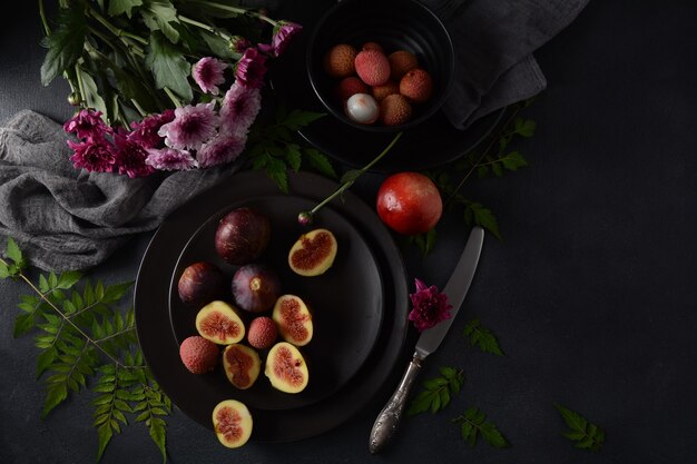 Raw fresh fig fruits on dark background. Slices of fresh common fig (Ficus carica)