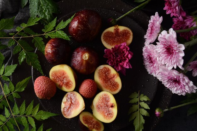 Raw fresh fig fruits on dark background. Slices of fresh common fig (Ficus carica)