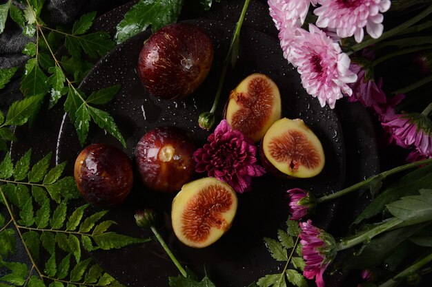 Raw fresh fig fruits on dark background. Slices of fresh common fig (Ficus carica)