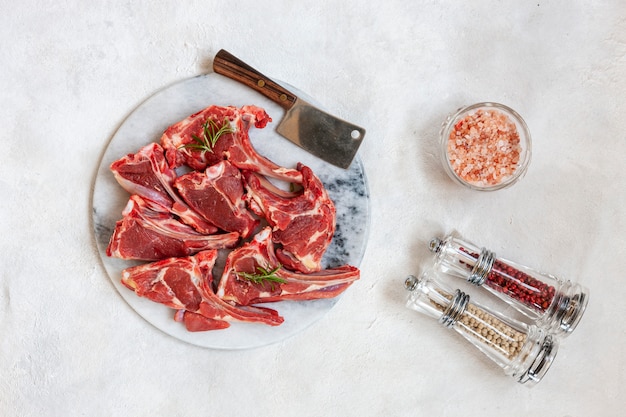 Raw fresh Lamb Meat ribs and seasonings on white surface