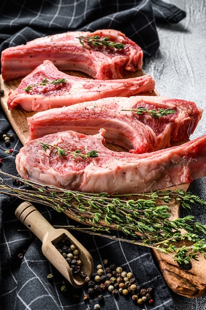 Raw fresh lamb ribs with pepper and thyme