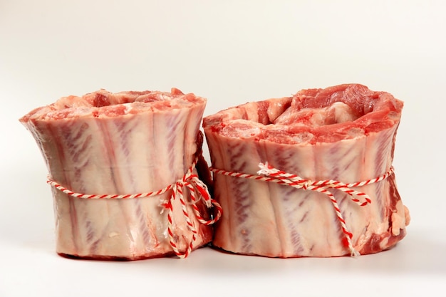 Raw fresh meat crown. Pork rib crown tied with decorative thread on a white background