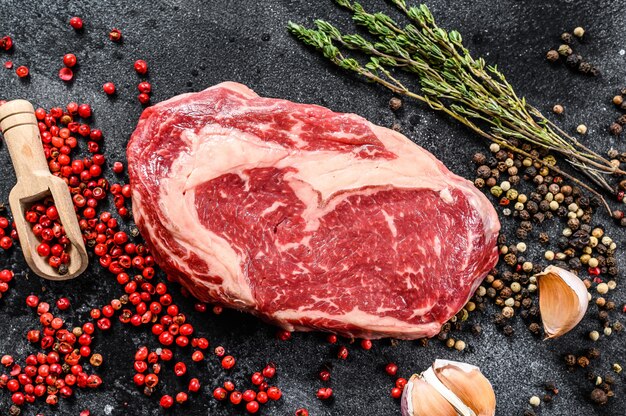 Raw fresh meat with seasoning on cutting board