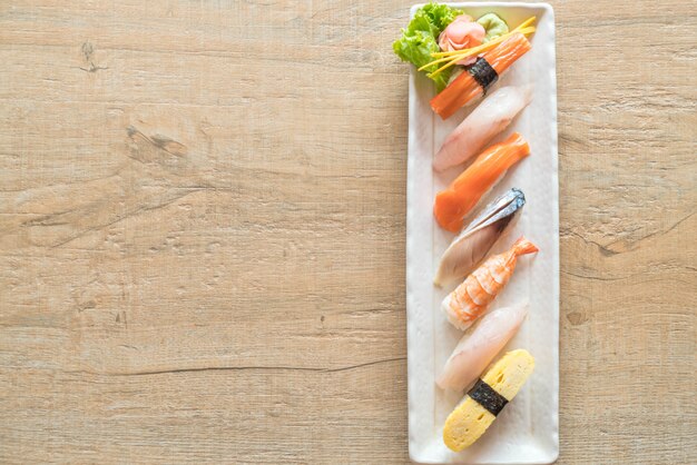 Raw and fresh nigiri sushi in white plate 