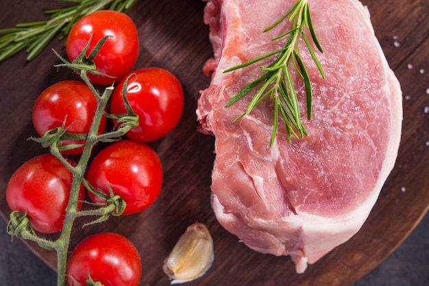 Raw fresh pork steak on a wooden board