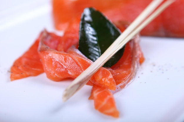 Raw fresh red salmon at white plate