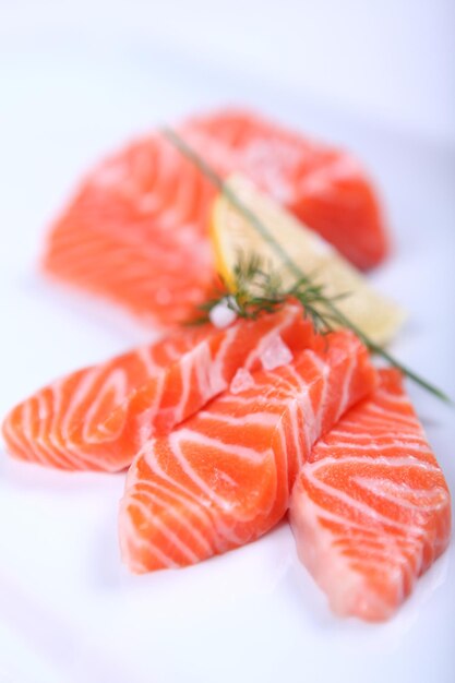 Raw fresh red salmon at white plate