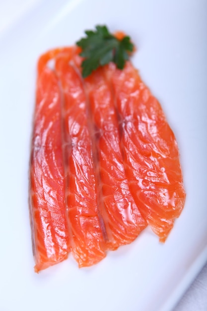 Raw fresh red salmon at white plate