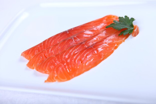 Raw fresh red salmon at white plate