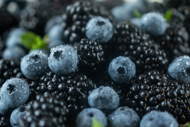 Raw fresh ripe juicy blackberries and blueberries closeup photo