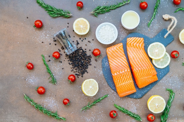 Raw and fresh salmon meat fillet on black stone slate