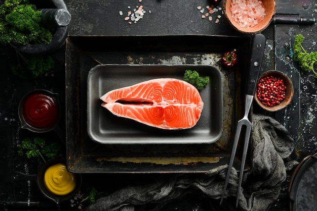 Raw fresh salmon steak Seafood on a black stone background Organic food