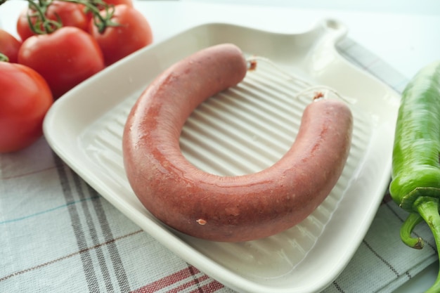 raw fresh Sausage and vegetables on table