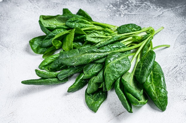 Raw fresh spinach leaves on a stone table.