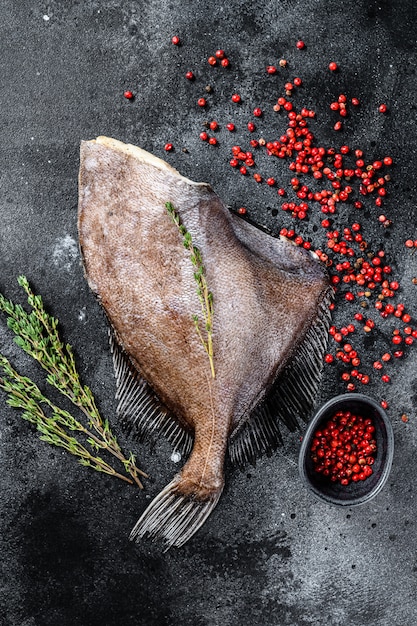 Raw fresh whole John Dory fish with spices and herbs for cooking. Top view.
