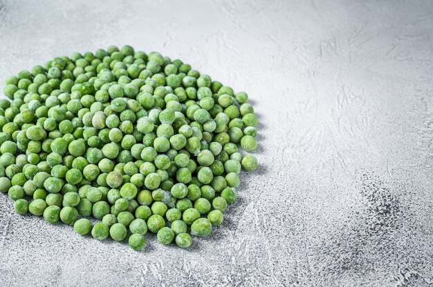 Raw Frozen green peas on kitchen table