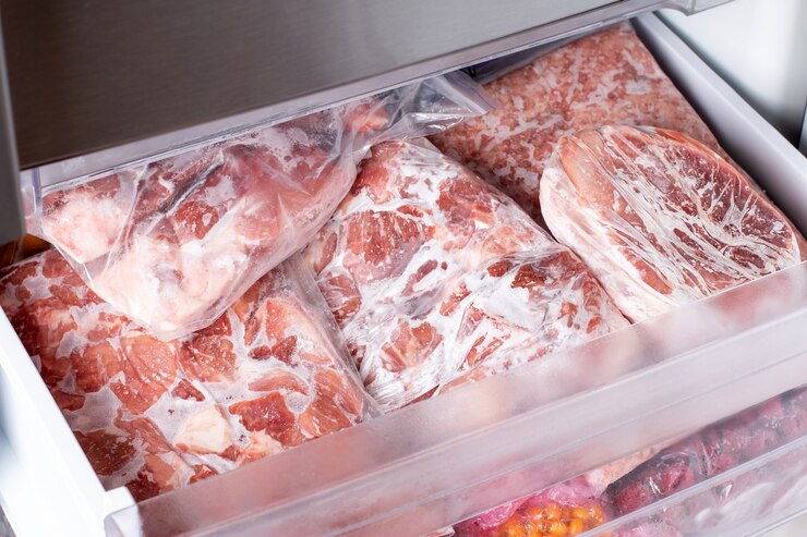Photo raw frozen meat. raw pork chops in the freezer. frozen food