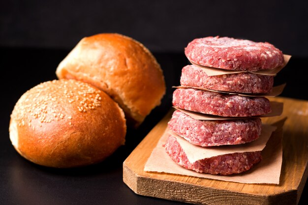 Raw frozen minced meat on wooden board