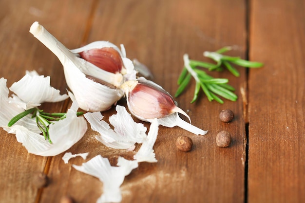 Raw garlic and spices on wooden table