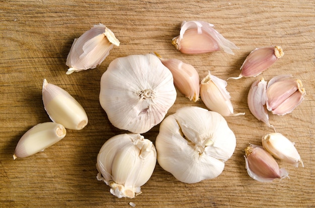 Raw garlic on a wooden plank