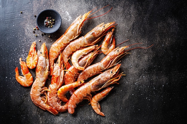 Raw giant shrimps on dark table