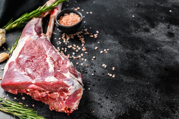 Raw goat leg with salt and garlic