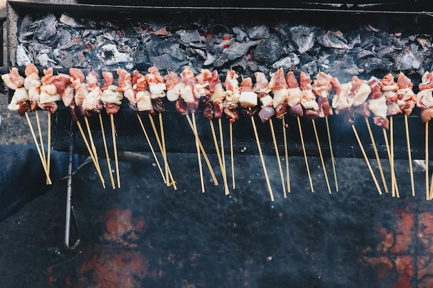 Raw goat satay lamb satay lamb or meat goat satay in grilling\
place with fire and smoke traditional satay from java\
indonesia