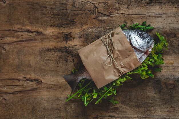 Raw  Golden fish in paper