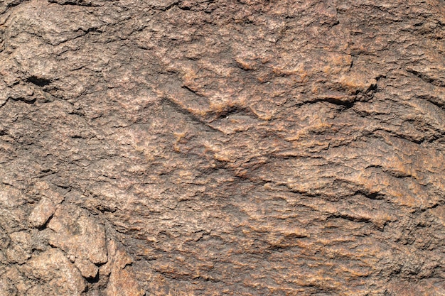 Raw granite rock texture background Fragment of natural stone wall