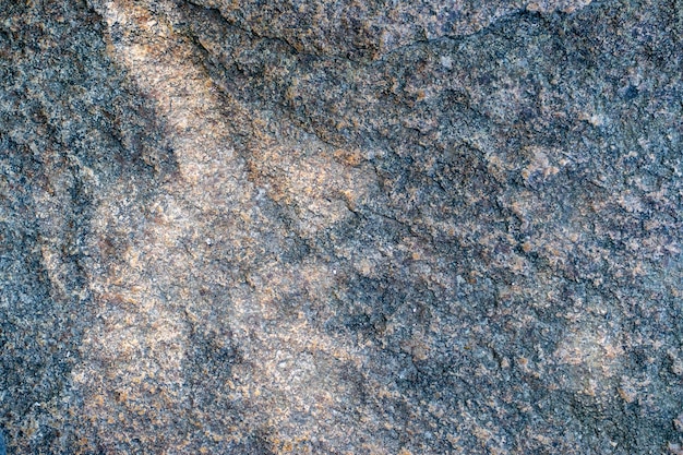 Raw granite rock texture background Fragment of natural stone wall