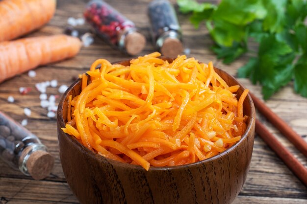 Raw grated spicy carrot salad in bowl