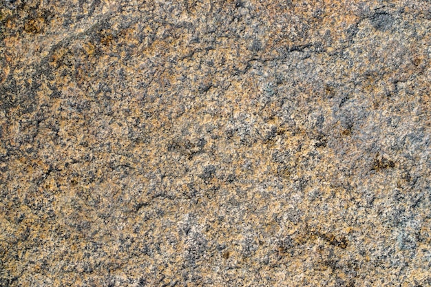 Raw gray granite rock texture background Fragment of natural stone wall