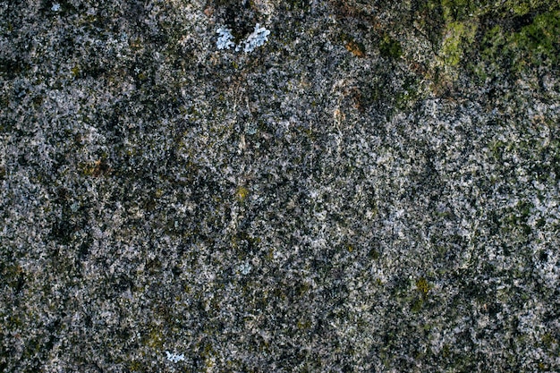 Raw gray granite rock texture background Fragment of natural stone wall