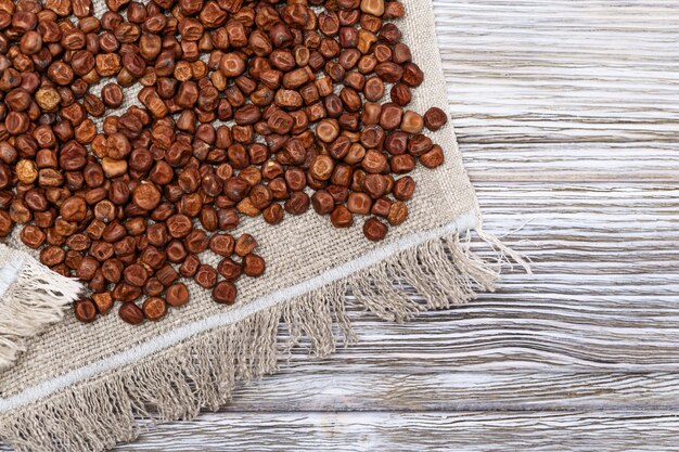 Raw gray peas on coarse cloth