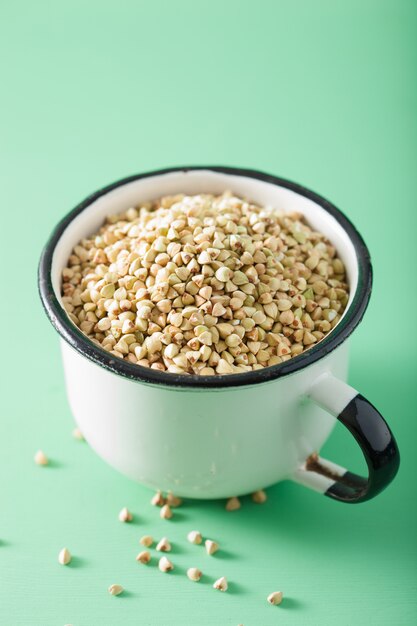 Raw green buckwheat in a cup