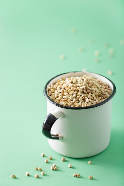 Raw green buckwheat in a cup