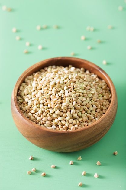 Raw green buckwheat in a wooden bowl