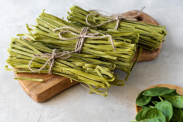 Raw green pasta fettuccine with spinaches