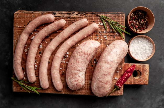 Raw grilled sausages with spices and rosemary