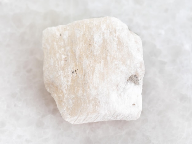 Photo raw gypsum stone on white marble