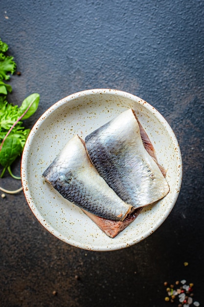 Raw herring fish on a plate