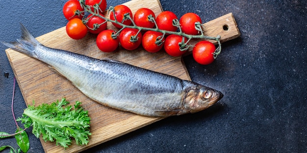 Raw herring fish on a wooden board