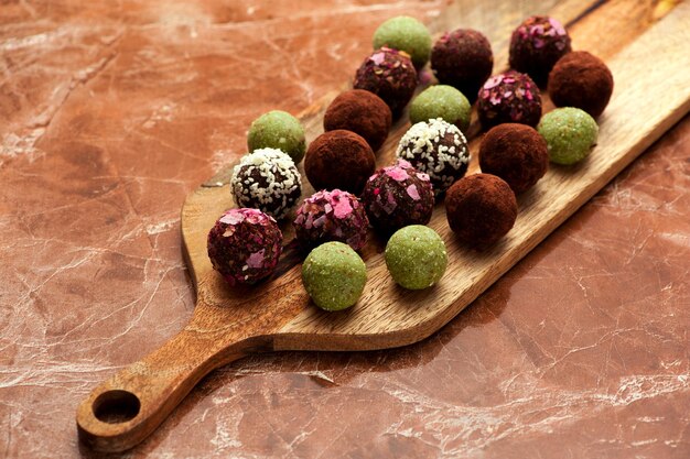 Raw homemade candy truffles on a marble background