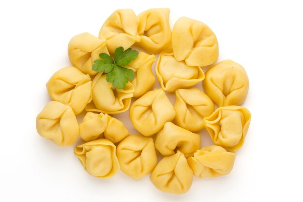 Raw homemade pasta,tortellini with herbs.