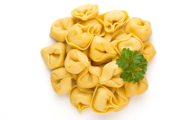 Raw homemade pasta,tortellini with herbs.