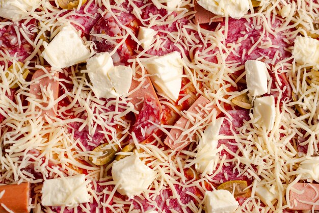 Raw homemade pizza closeup Pizza background with mozzarella cheese and salami