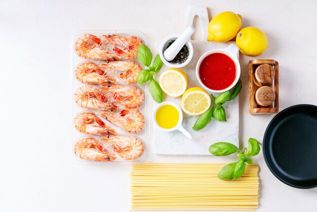 Raw ingredients for cooking: Shrimp prawns Italian spaghetti