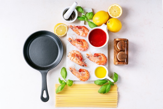 Raw ingredients for cooking: Shrimp prawns Italian spaghetti